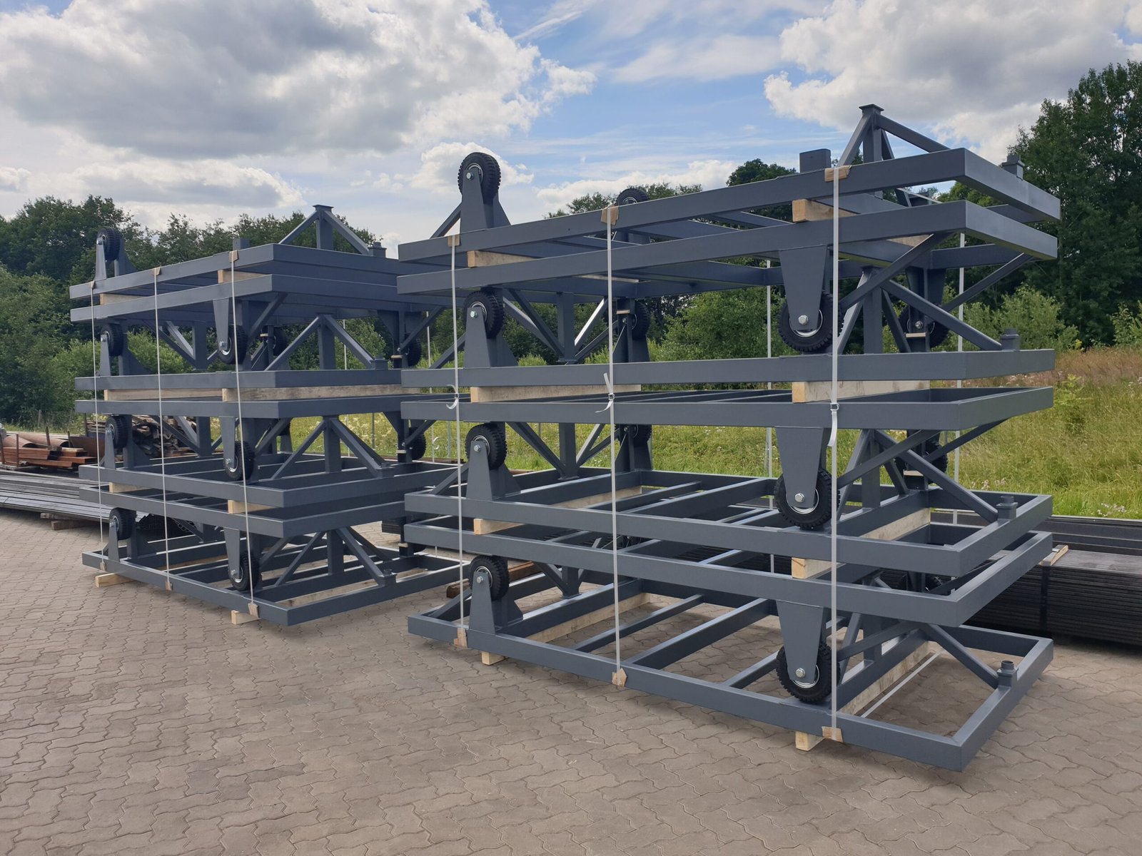 Stacked steel handling units illustrating compact storage of reusable industrial packaging